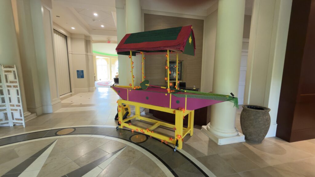 Koshur Chaan Woodworking Artisan hardwood cart with green and red roof, yellow frame, floral pink panels, and duck cutout; handcrafted in Georgia. Johns Creek, GA